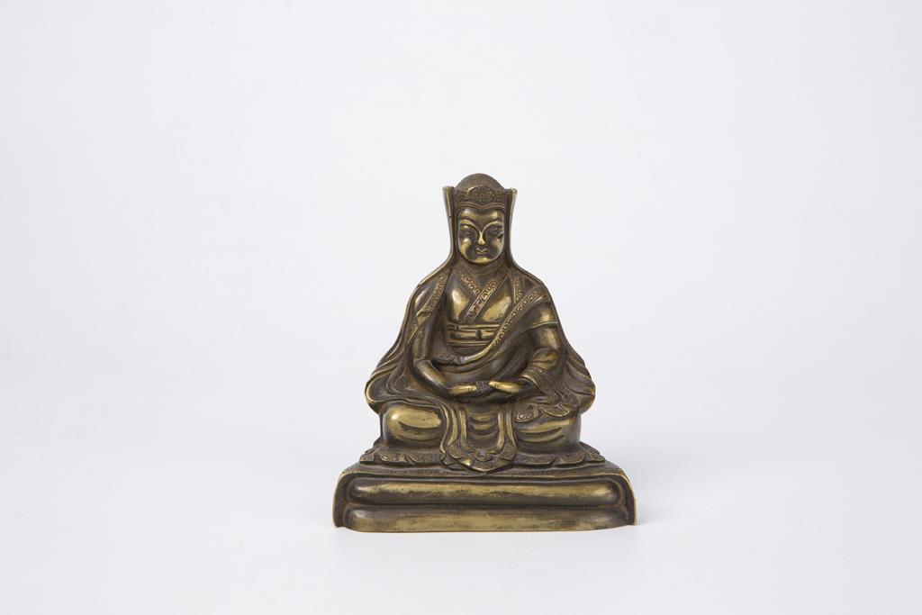 Bronze Figure of Karmapa Lama, 17th-18th Century: Tibet, 17th-18th century Dimensions: 4 3/8" (11cm) H Modelled seated on a square base, his legs crossed under his long robes and hands together resting on his lap, with serene expression and wearing h