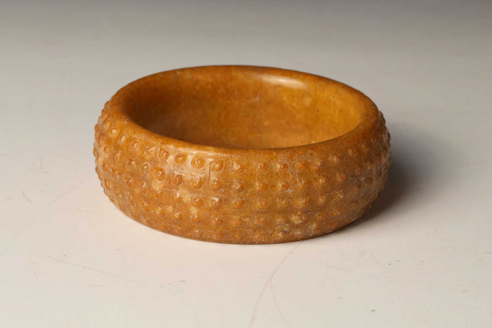 Yellow Jade Bangle: Dimensions: 2 3/4" (7cm) H Inner Dia ,3 1/2"(9cm) Outer DiaDecorated with protruding beads on the outer surface.黃玉鐲