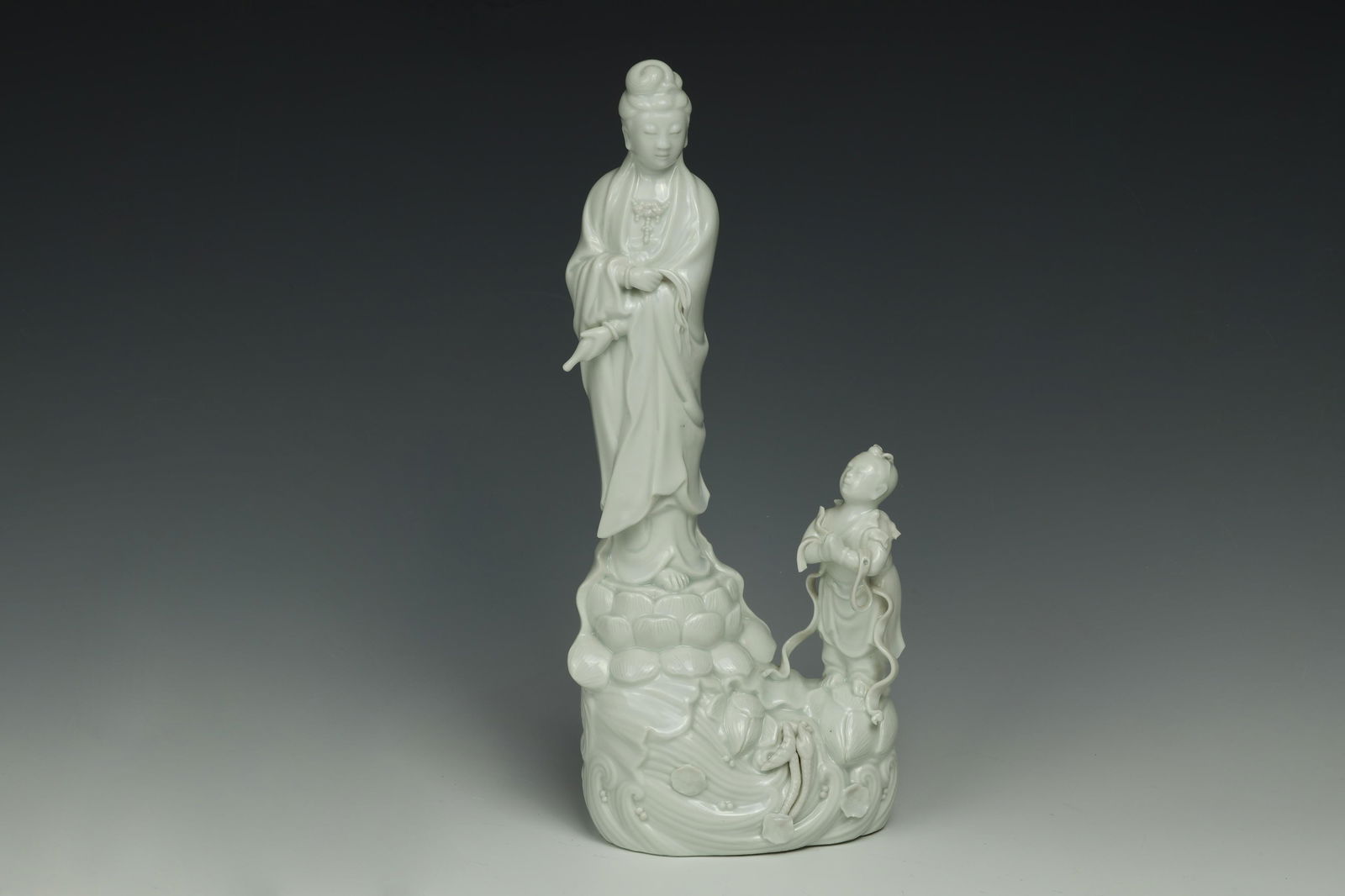 Dehua Blanc-de-Chine Guanyin and Attendant Group: Dimensions: 12" (30.5cm) H 20世纪德化白釉童子拜观音雕像