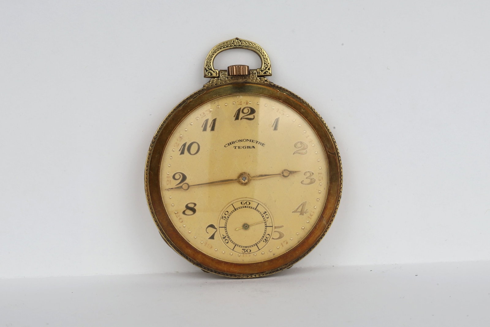 Tegra Chronometre Pocket Watch: Tegra Chronometre Pocket WatchMovement Setting: PendantWind Mechanism: PendantCase Metal: Gold FilledDimensions: 4.9cm Dia