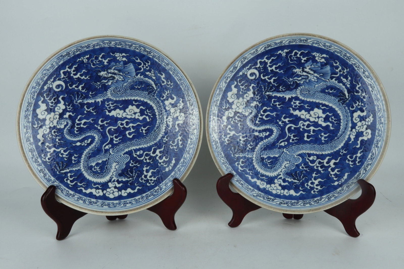 A Pair of Blue and White Circular Porcelain Plaques China Qing Dynasty: A Pair of Blue and White Circular Porcelain Plaques China Qing Dynasty Dimensions: 27.3cm Dia 清代青花圆瓷板一对，带底托 &