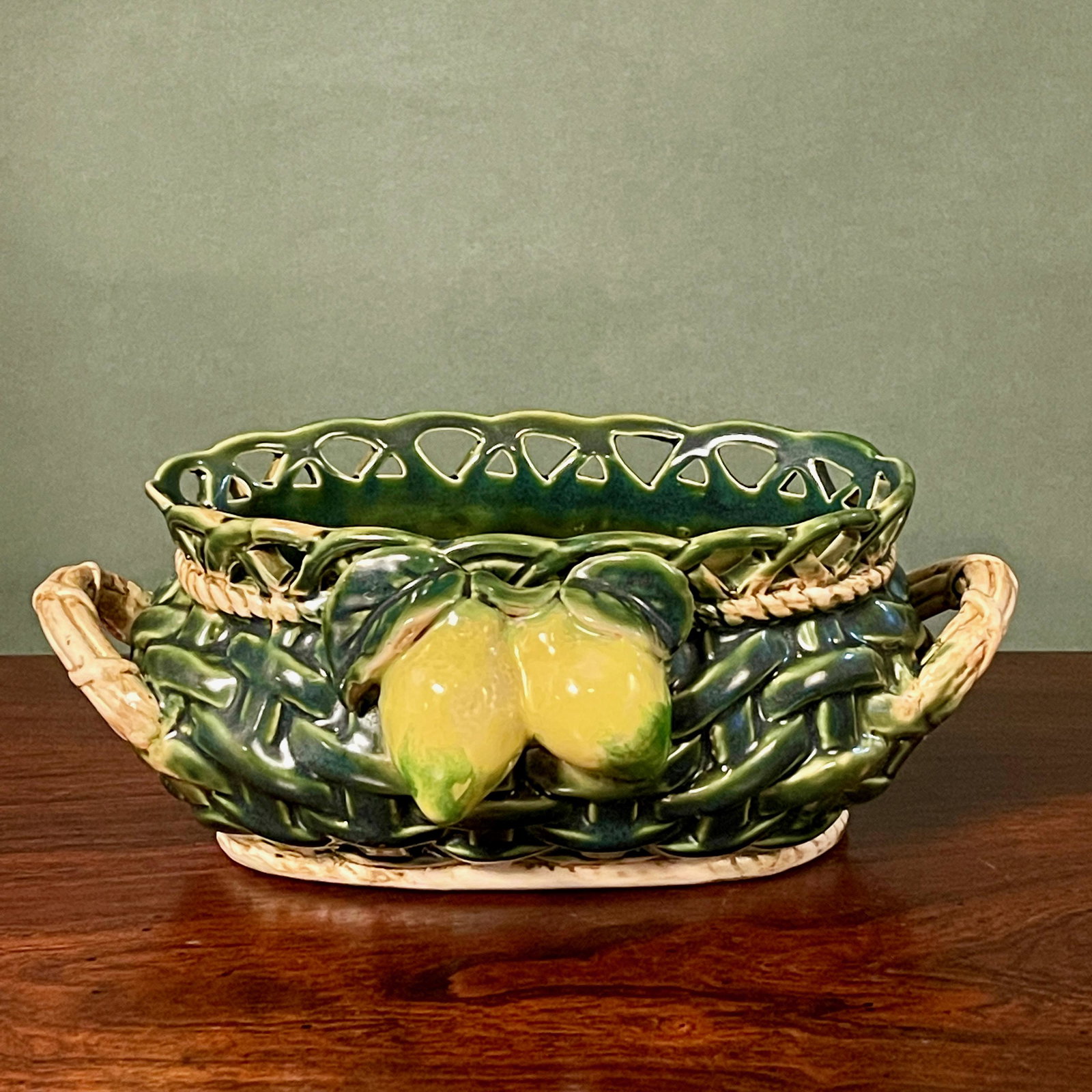 French Majolica Ceramic Woven Basket w/ Lemons: French Majolica Ceramic Woven Basket w/ Lemons. 9”W x 5.5”D x 3.5”H.