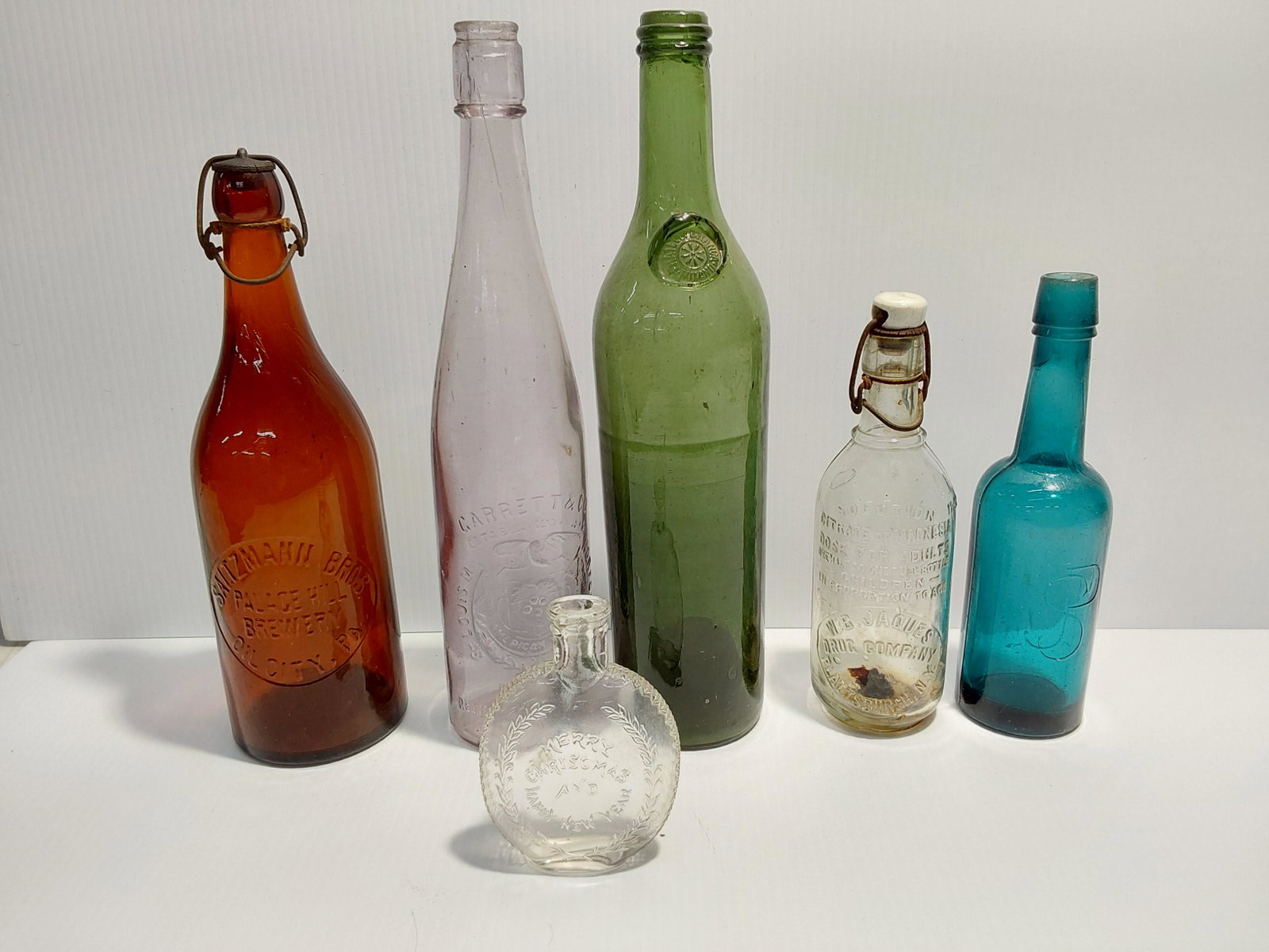 bottle lot: W.B. Jaques Drug Co, Carrett & Co, Saltzmann Bros, Merry Christmas flask