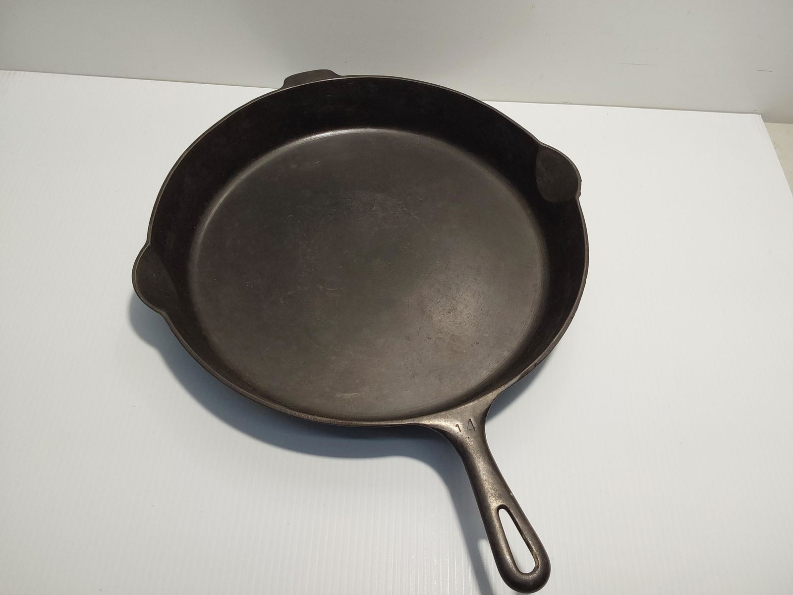Griswold #14 skillet: Large logo, with fire ring.Has a wobble.