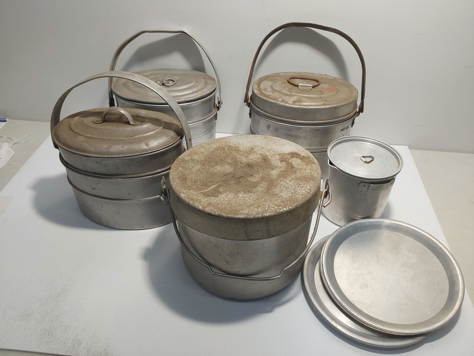 lunch pails & bucket: (3) miner's lunch pails and a bucket with plates.