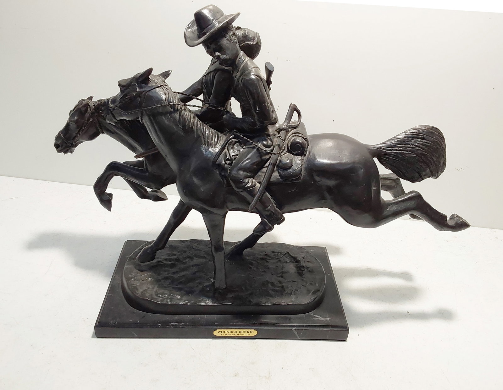 Fredrick Remington bronze statue: "Wounded Bunkie" 27" long and 19" high