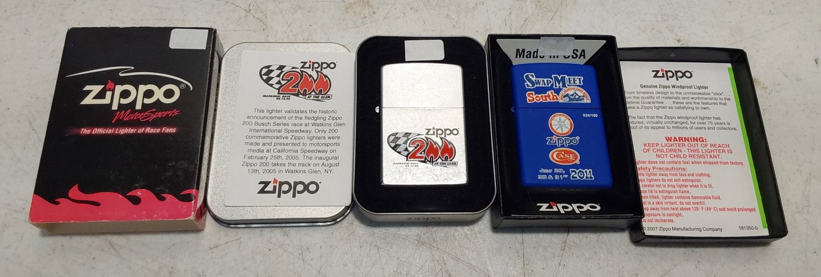 (2) unused collectible Zippo lighters: (1) 2011 Smokey Mountain Swap Meet South Blue Matte finish Zippo lighter in box. Unused. (1) 2005 Zippo 200 Motorsports Street Chrome finish Zippo lighter in tin with sleeve. Unused.
