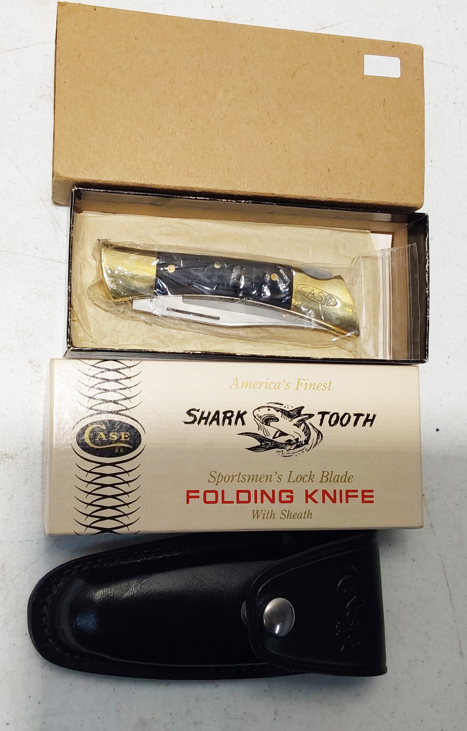 1974 Shark Tooth Lock Back Knife: 1974 Shark Tooth (7197 L SSP) Lock Back Knife, 3 3/4" clip blade, 5" wood handles with brass bolsters, rear bolster has stamped Case oval logo, blade has "Shark Tooth" etching, (8 1/2" overall length)