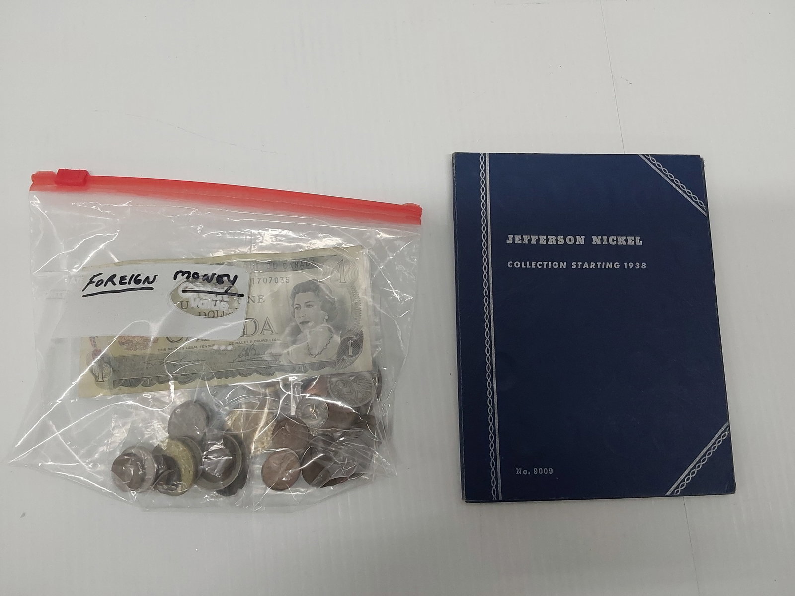 Foreign money and book of Jefferson nickels: (1) Canadian dollar, (45) miscellaneous foreign coins, (1) 1923 10,000 mark (large coin) Also, 1938 Nickel book with (10) silver nickels (35%), ($2.60 face value)