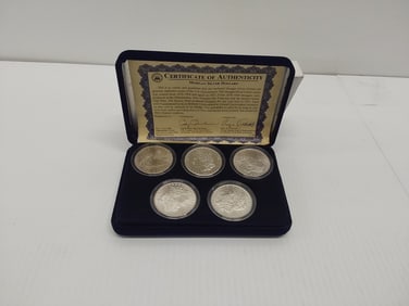 (5) Morgan silver dollars in case