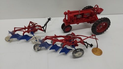 flat with tractor model and (2) plows