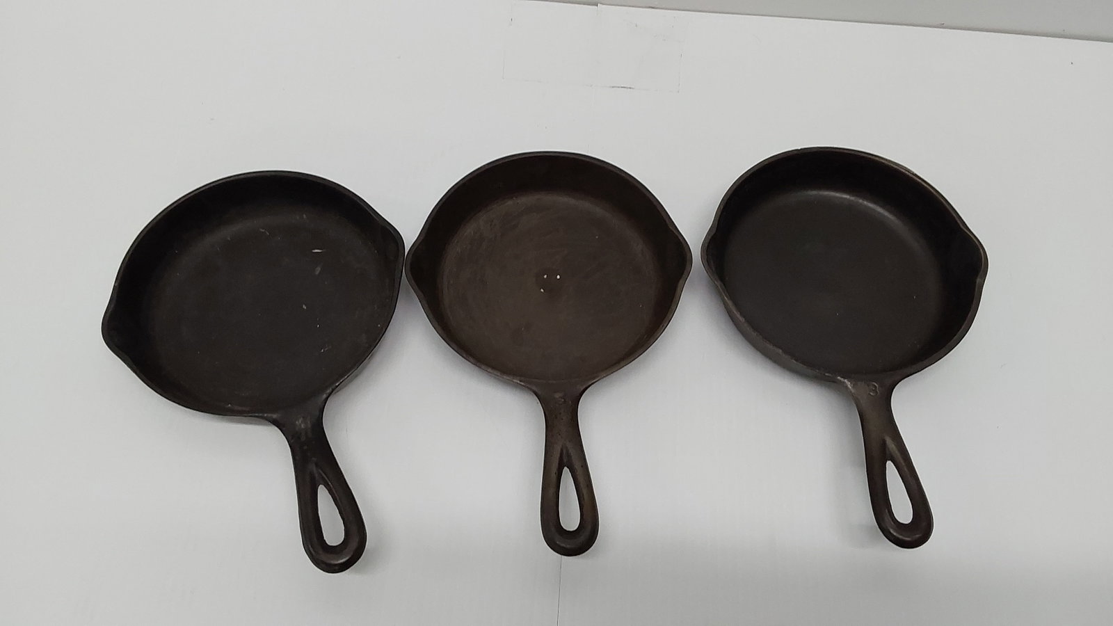 (3) #3 cast iron skillets: (2) Wagner and (1) unmarked