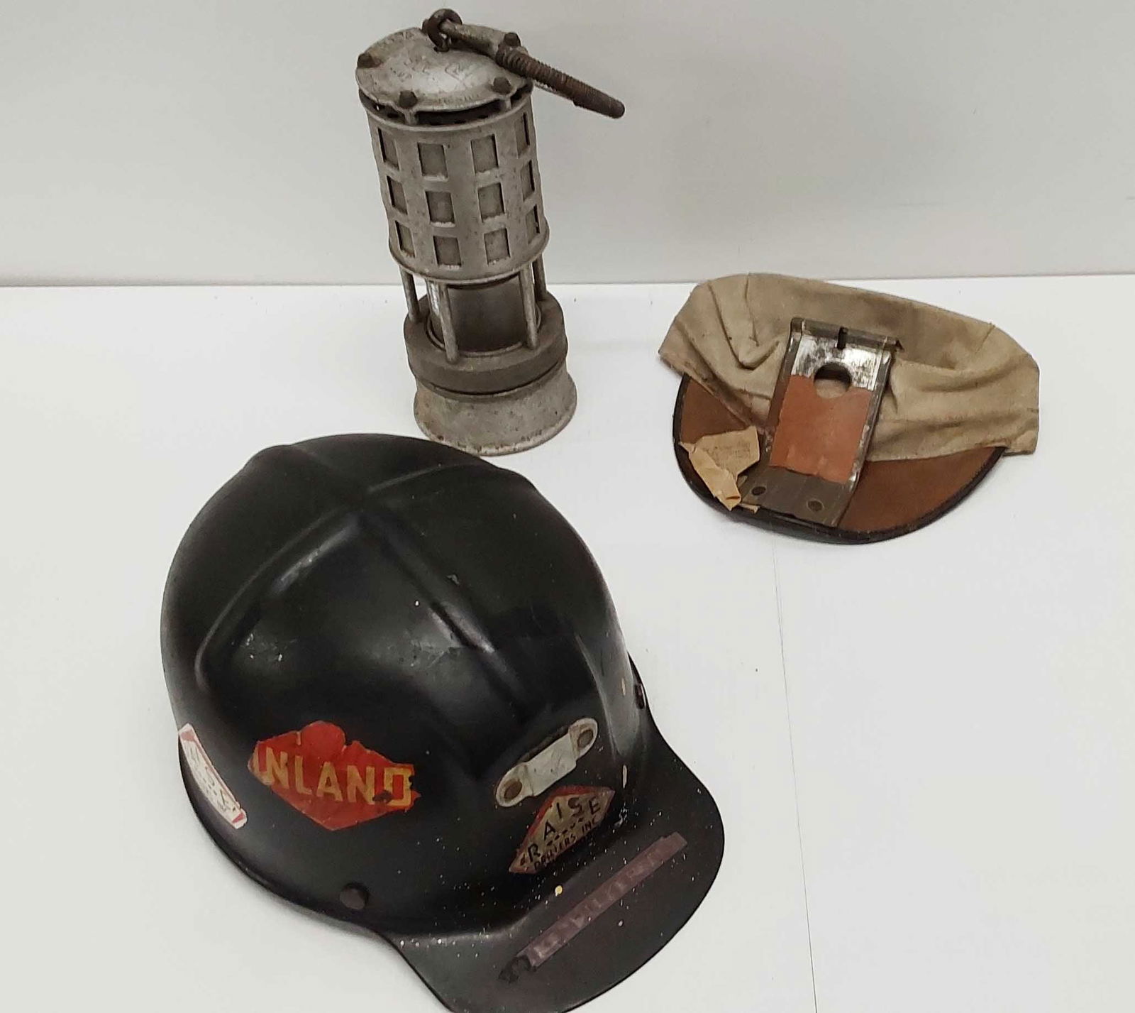 flat of caps: miner's safety lamp, cloth cap, comfo cap (no liner)