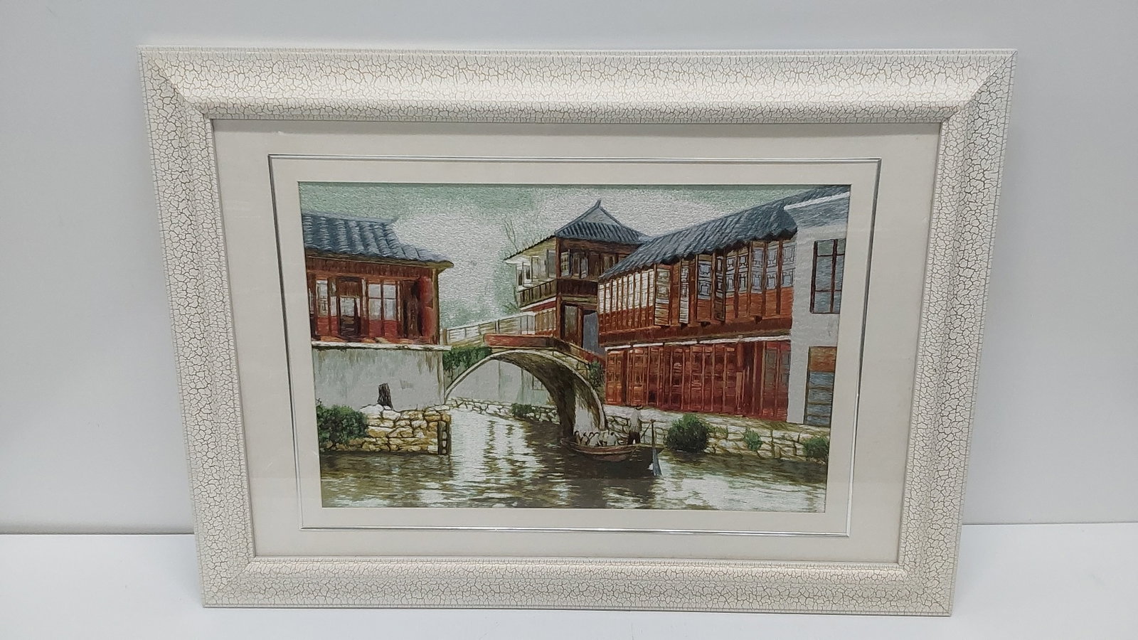 framed embroidery with canal scene: 25" x 34 1/2"