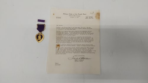 Purple Heart award and ribbon with paperwork