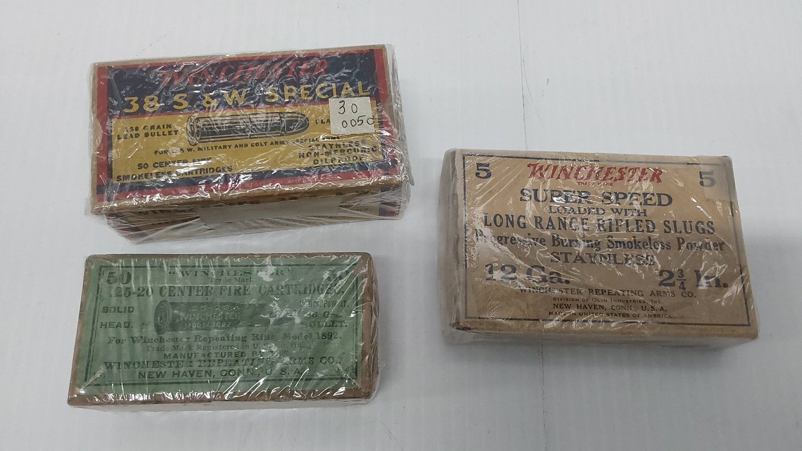 (3) vintage ammo boxes: (1) .38 Special S&W Winchester box only. (1) Winchester 25-20, rough and damaged box only (1) Winchester 12ga slugs - partial full