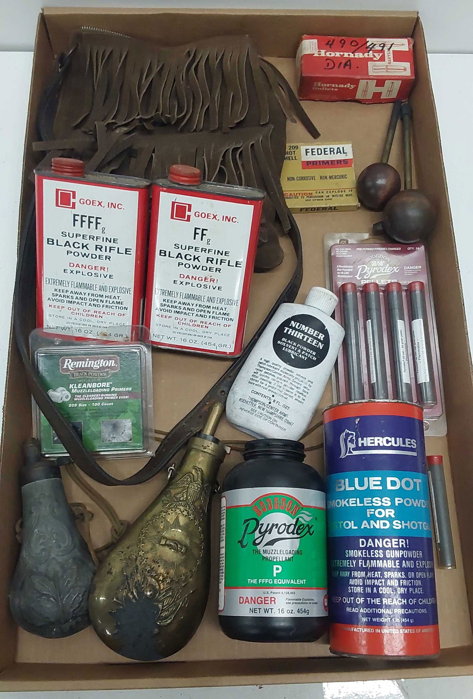 flat of muzzleloader supplies: black powder, flask, leather bag and miscellaneous