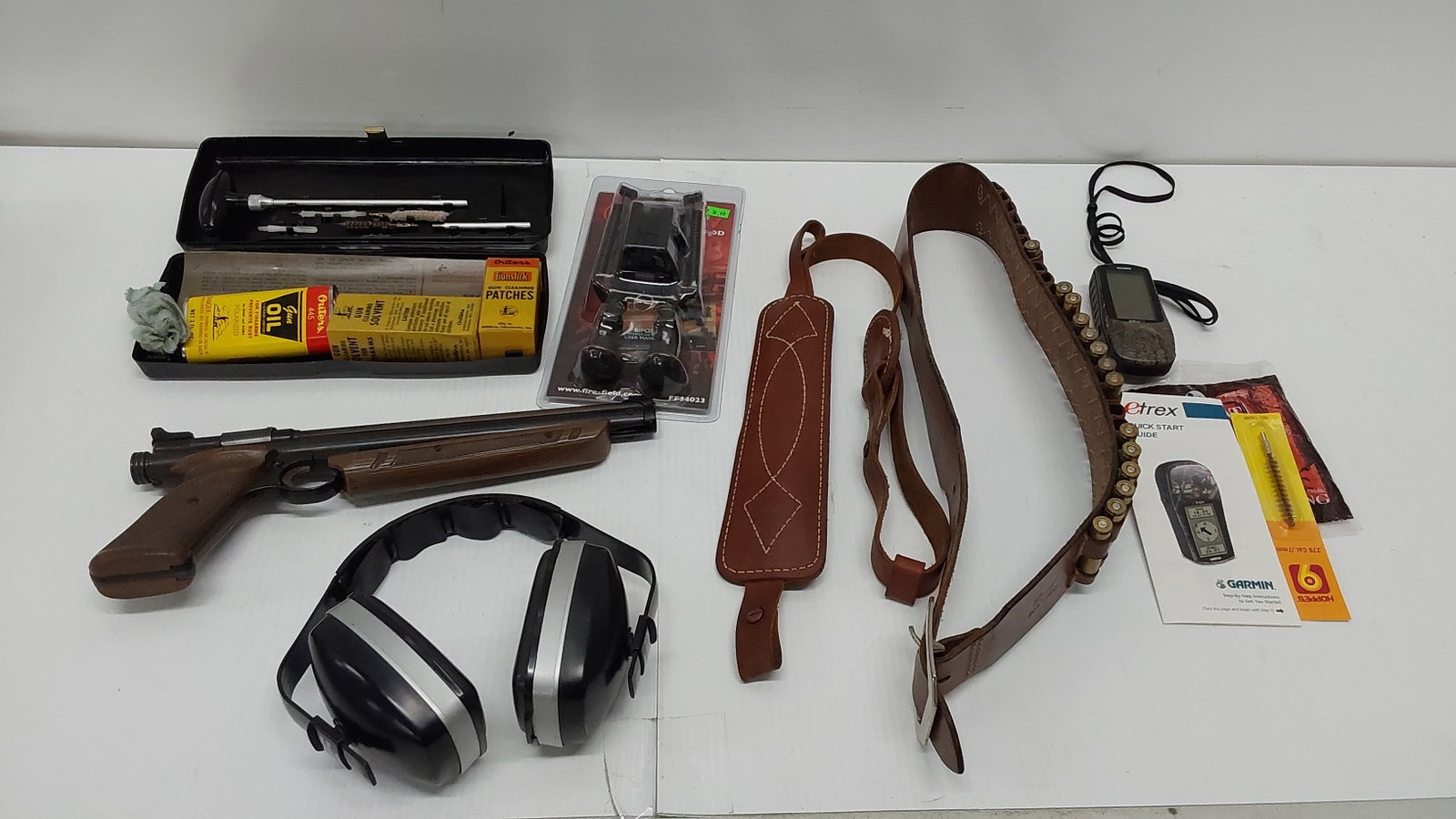 miscellaneous hunting/shooting and some ammo: ear muffs, BB pistol, Garmin, gun cleaning kit, sling, (13) rounds of 270 and ammo belt.