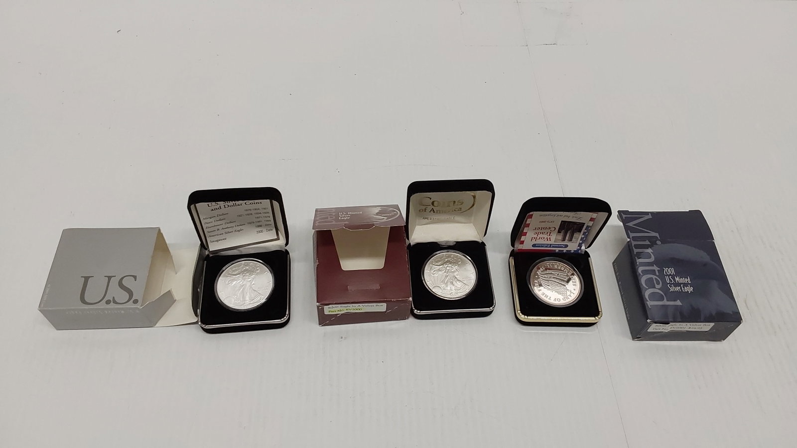 (2) silver Eagles and (1) WorldTrade Center round: Eagles 2000 and 2001 in cases