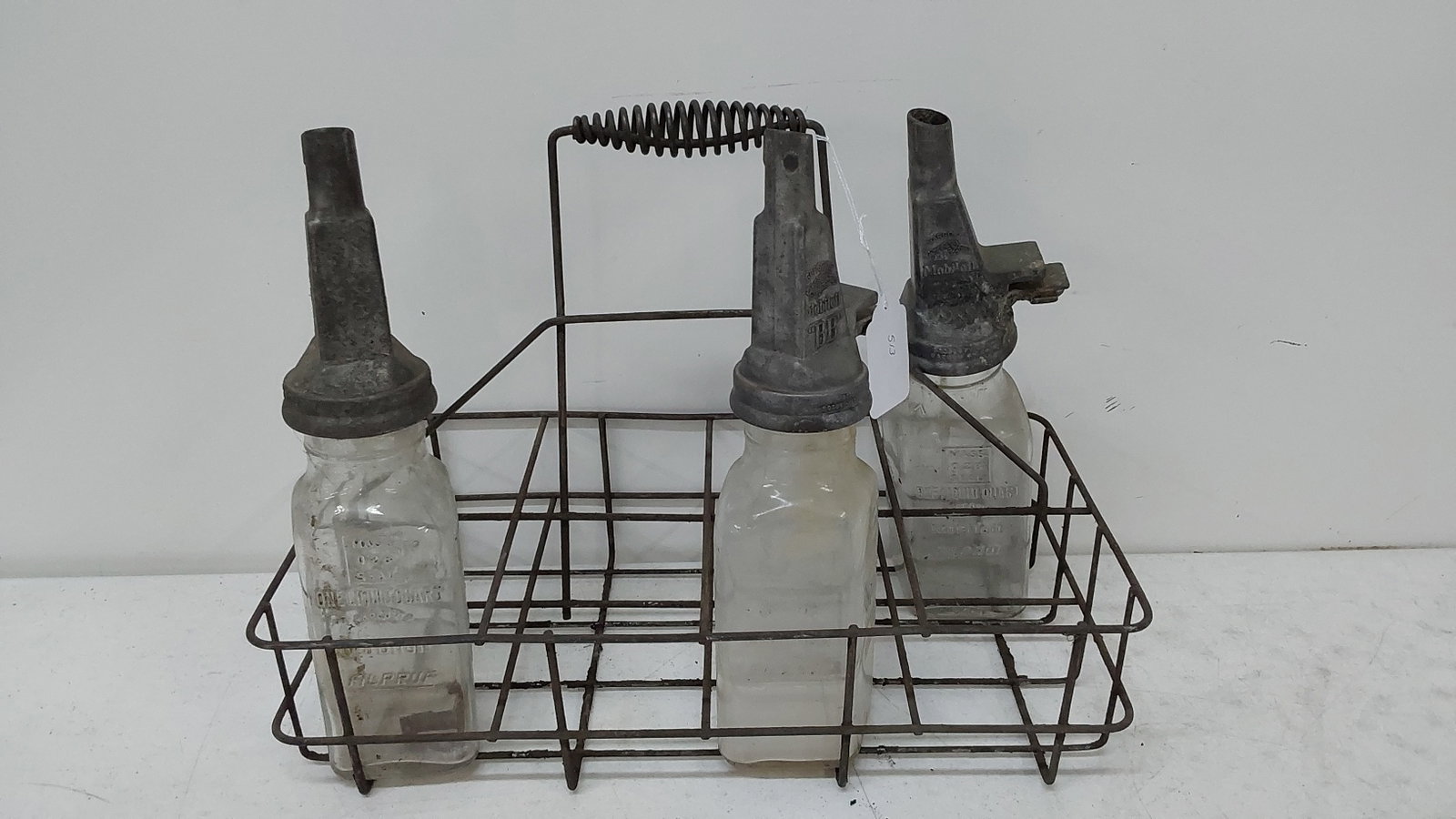 (3) MobilOil jars with Gargoyle logo: Jars feature a proprietary filling feature.Jars would only be able to be filled at MobilOil station. and jar tops cannot be removed. Not the correct oil carrier.