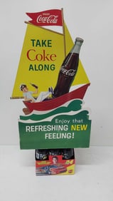 6-pack of Coca-Cola bottles w/cardboard sign
