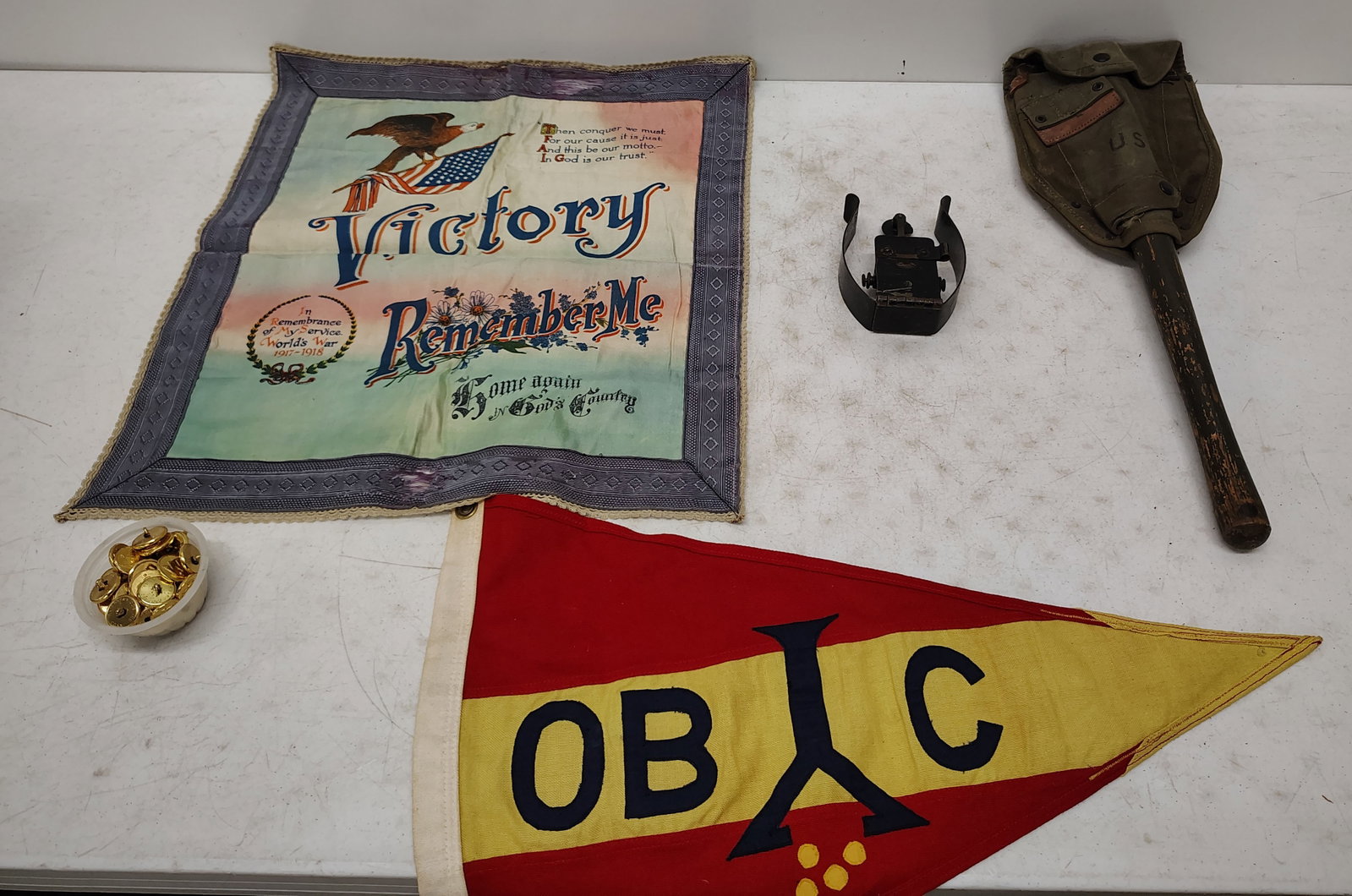 military lot: military buttons, military flags, military code machine, trench shovel