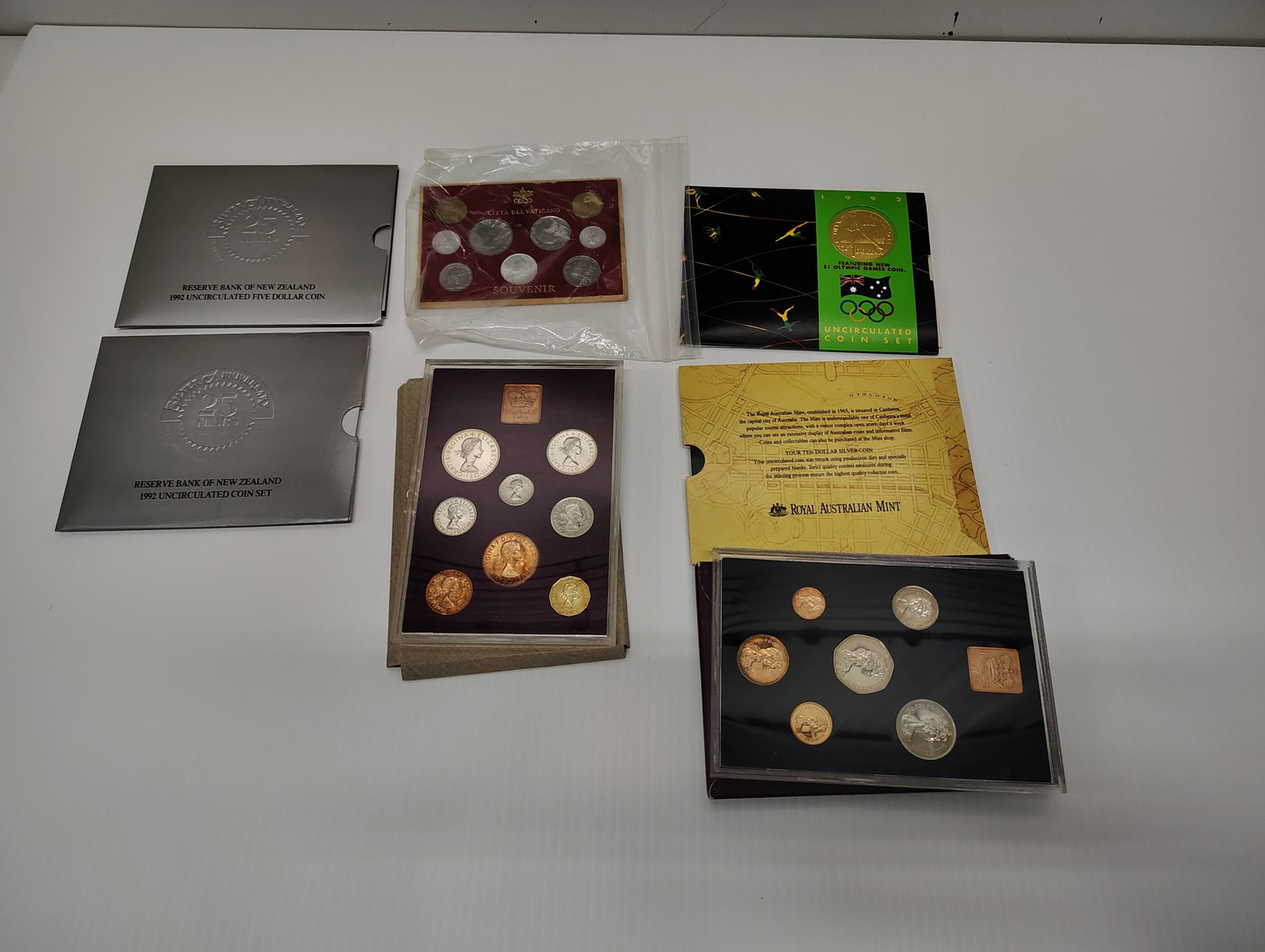 coins: (2) 1992 uncirculated coin set New Zealand Citta del Vaticano coins (2) 1970 coin set Great Britian and Ireland Elizabeth R 1993 $10 silver uncirculated coin