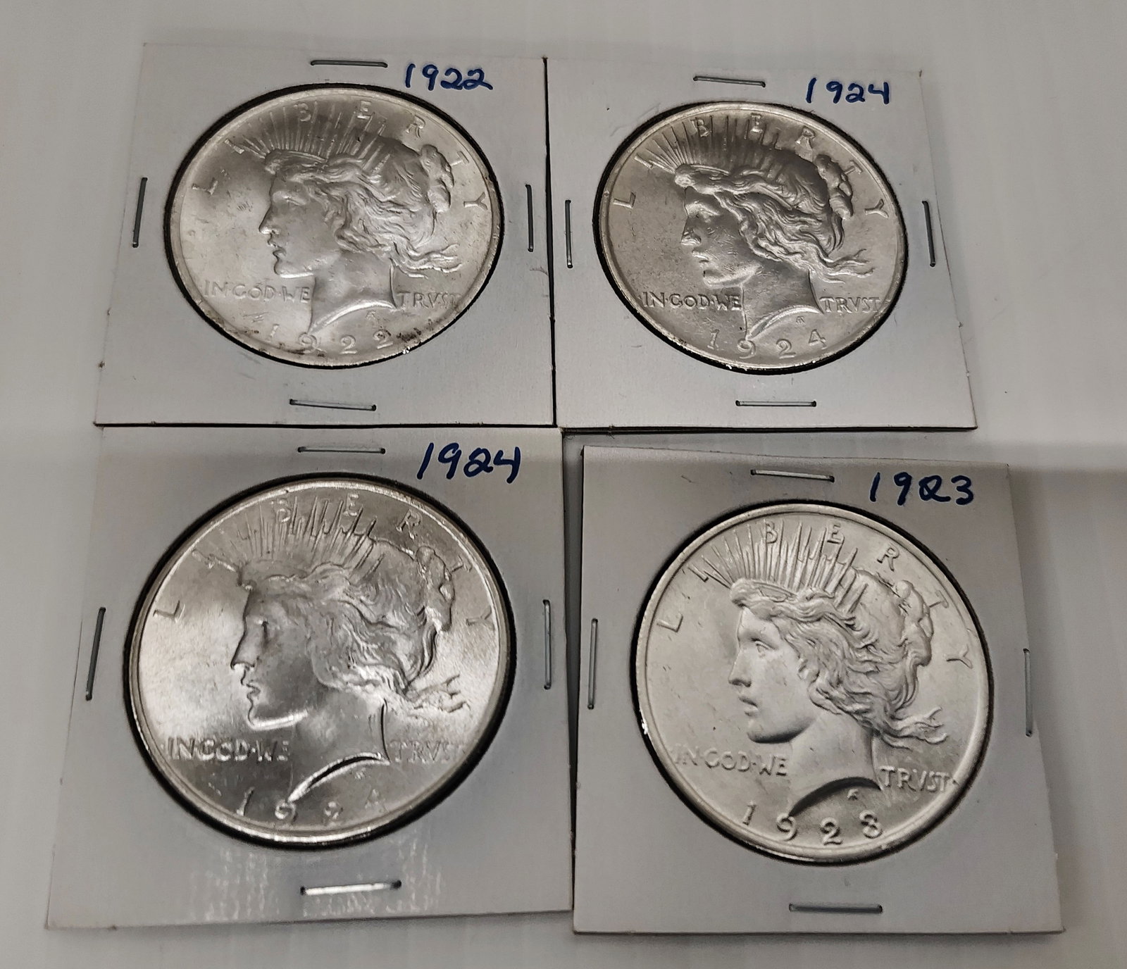 coins: 4 peace silver coins 1922, 1923 and (2) 1924