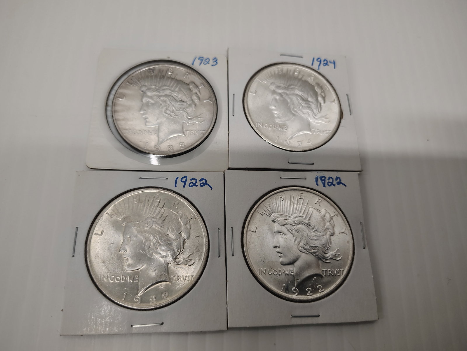 coins: 4 peace siver coins 1924, 1923 and (2) 1922
