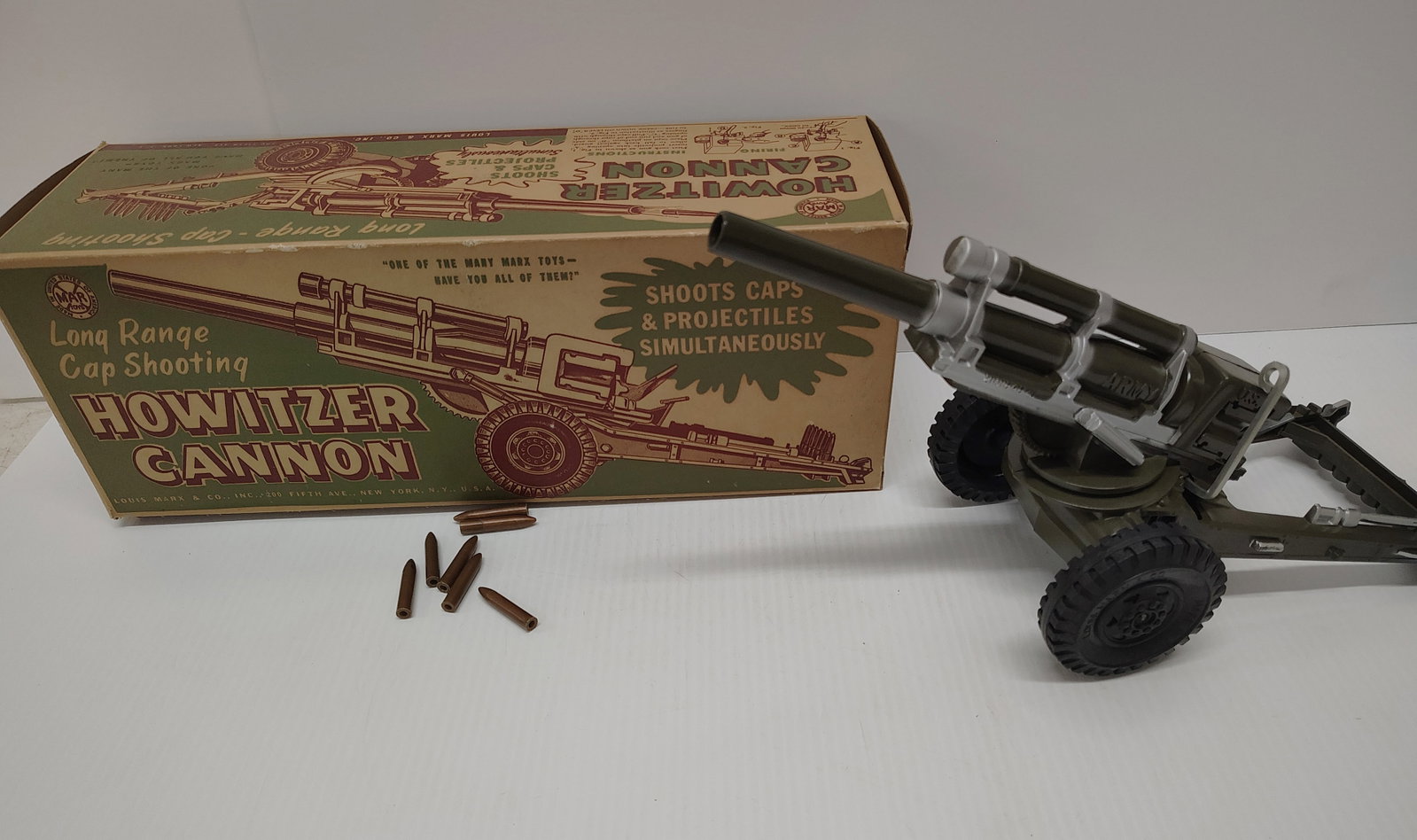 toys: Mmarx howitzer cannon with 7 of the 8 shells good condition