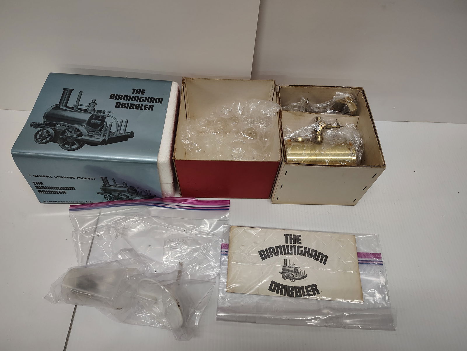 toys: steam model engine by Maxwell Hemmens and a vintage Saito high ability precision boiler and alcohol burner has some rust