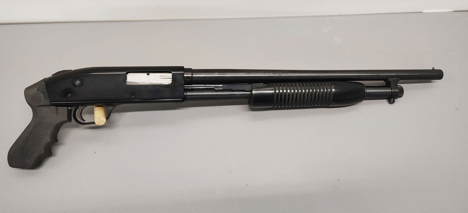 gun: Mossberg serial number: L023401 16 gauge pump with pistol grip camo case