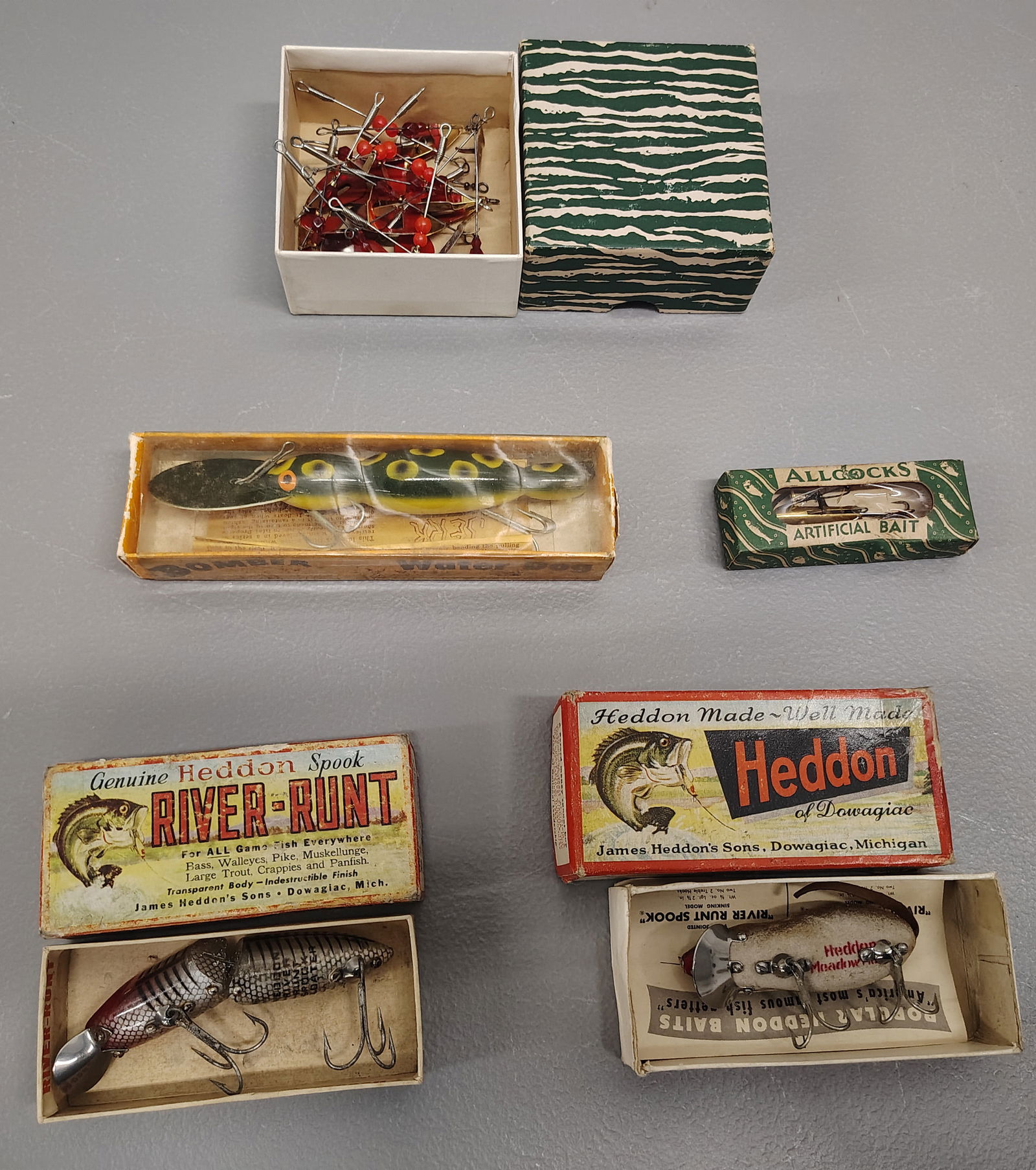 Fishing items: bomber water dog heddon-meadow pflueger june bug all cocks bait- devon minnow heddon-river runt