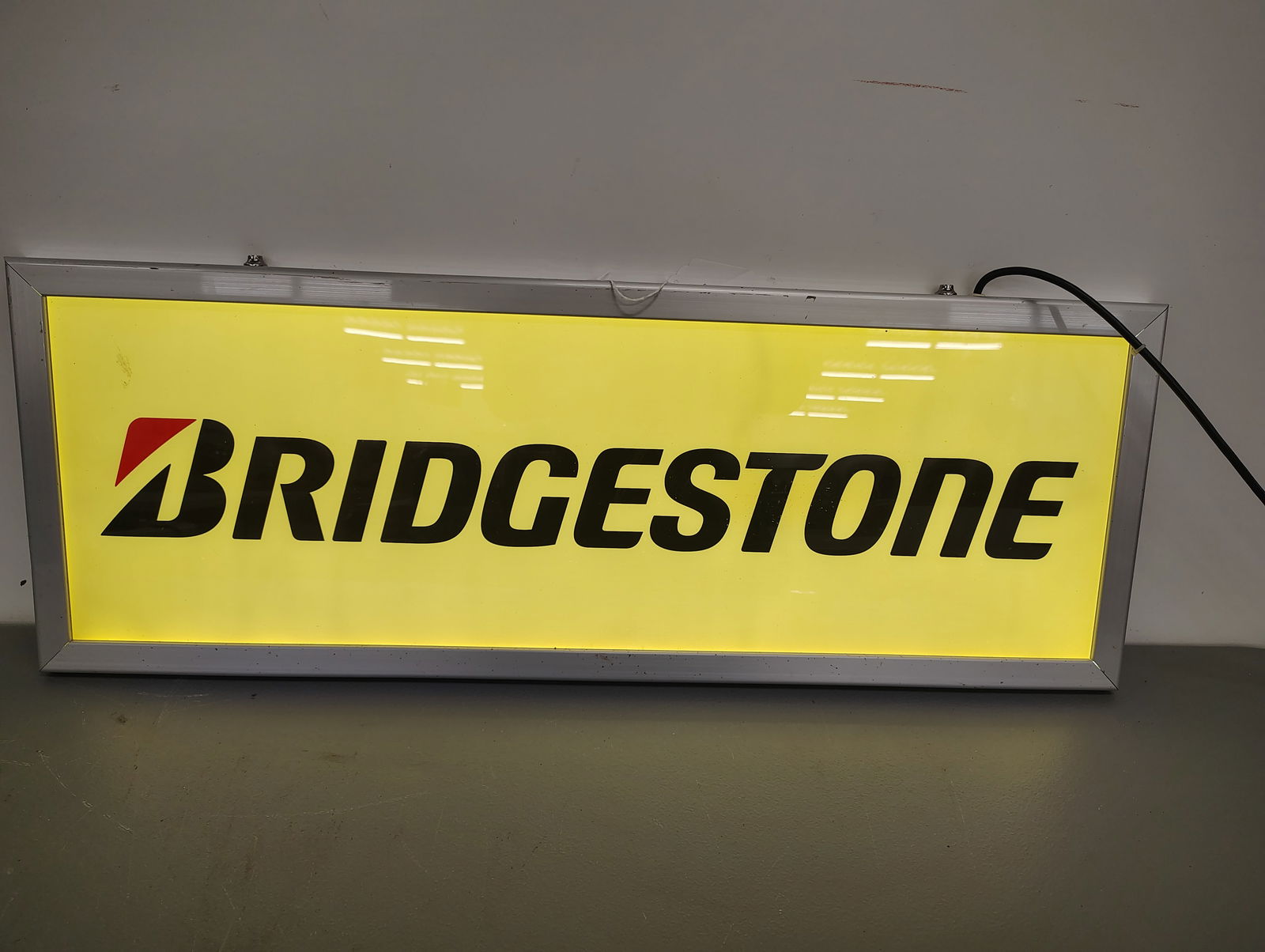 Sign: Bridgestone lighted sign lights up and works double sided