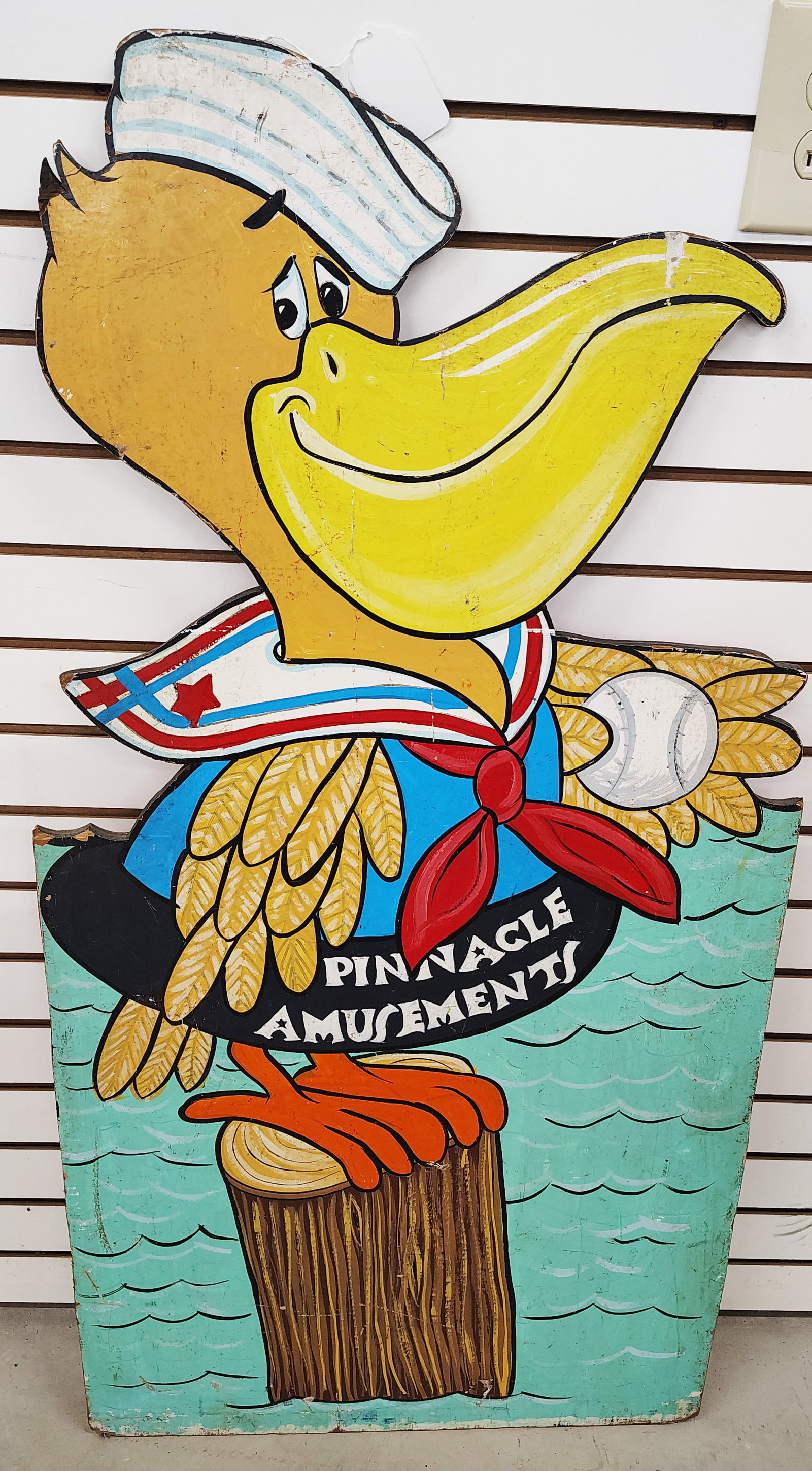 Sign: Pinnacle amusement park pelican made out of plywood