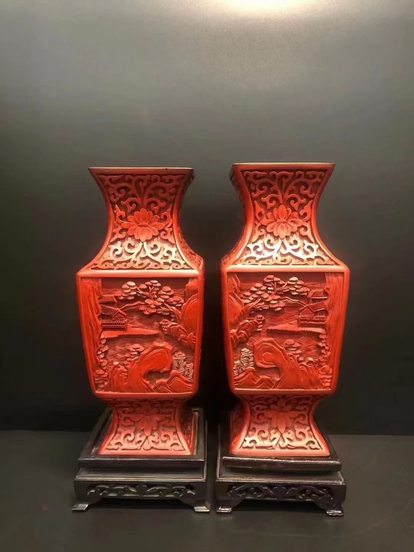 A pair of carved lacquer square bottles for a landscape pavilion: A pair of red landscape square bottles, 27cm high, paired with a dignified and regular shape. The mouth and neck are intricately carved with precious flowers and branches, and the landscape of mountai