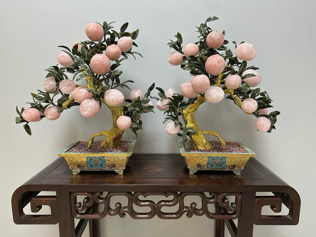A pair of Qing Dynasty palace style crystal longevity peach bonsai: A pair of gilded cloisonn enamel pink crystal peach bonsaiSpecification: 70cm high, gilded tree trunk, ink jade leaves, pink crystal longevity peach, cloisonn ?? gilded square basin, paired and comple