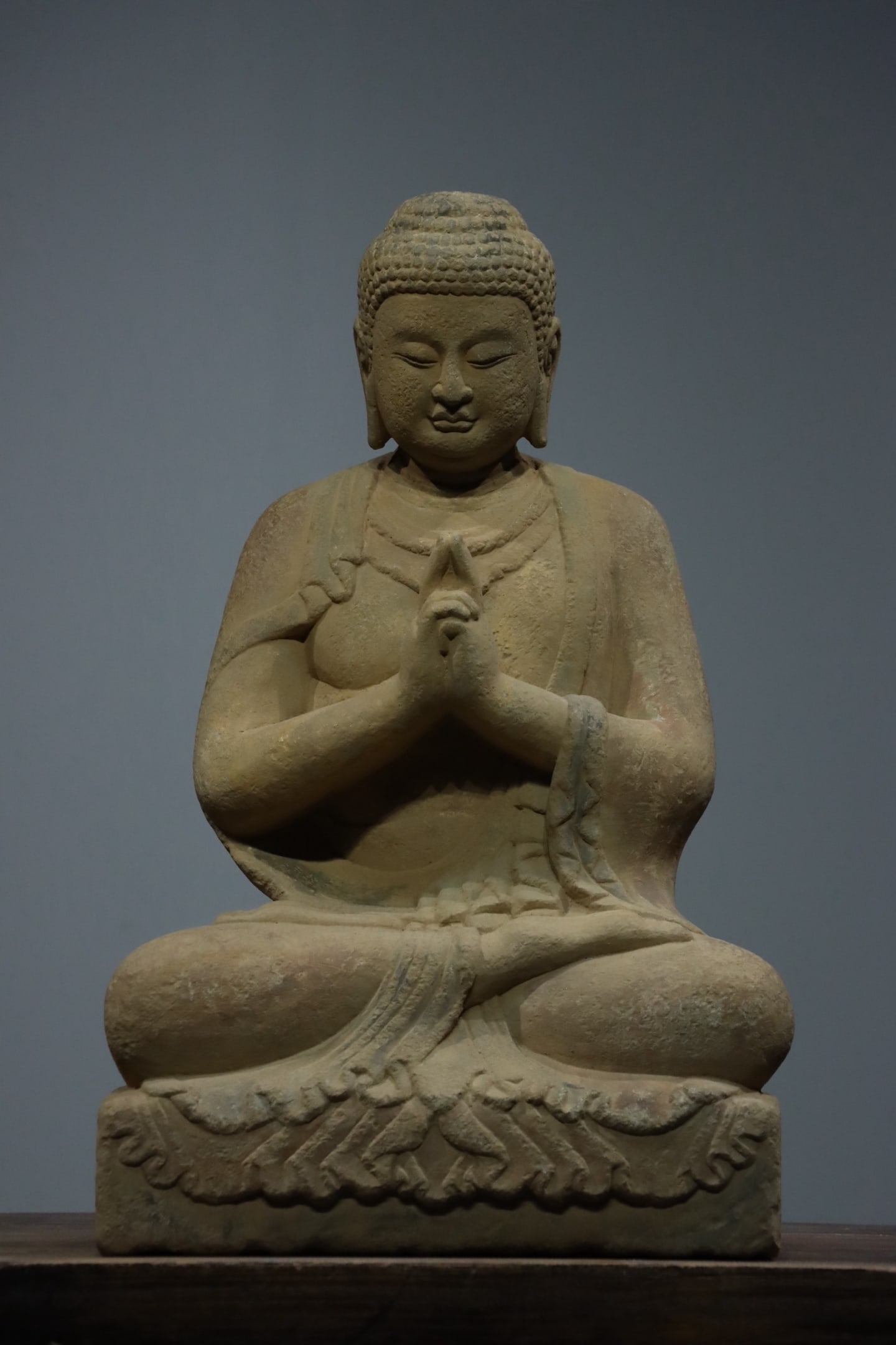 Qing Dynasty sandstone Buddha statues: The ancient stone carving of Shakyamuni sitting with palms clasped together, measuring 60cm in height and 38cm in width. Made of sandstone material, with regular spiral hair, the face is serene and so