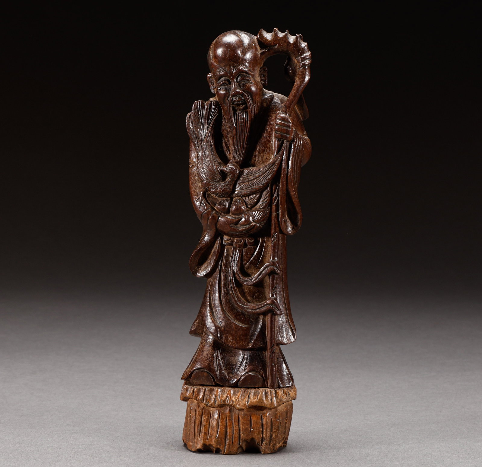 Huanghua Pear Longevity Star from Qing Dynasty or before: Old Tibetan wooden crane longevity star ornament, with a height of 21.5cm, a width of 5.6cm, and a weight of 236g. The whole material is round carved, with the longevity star holding a staff and holdi