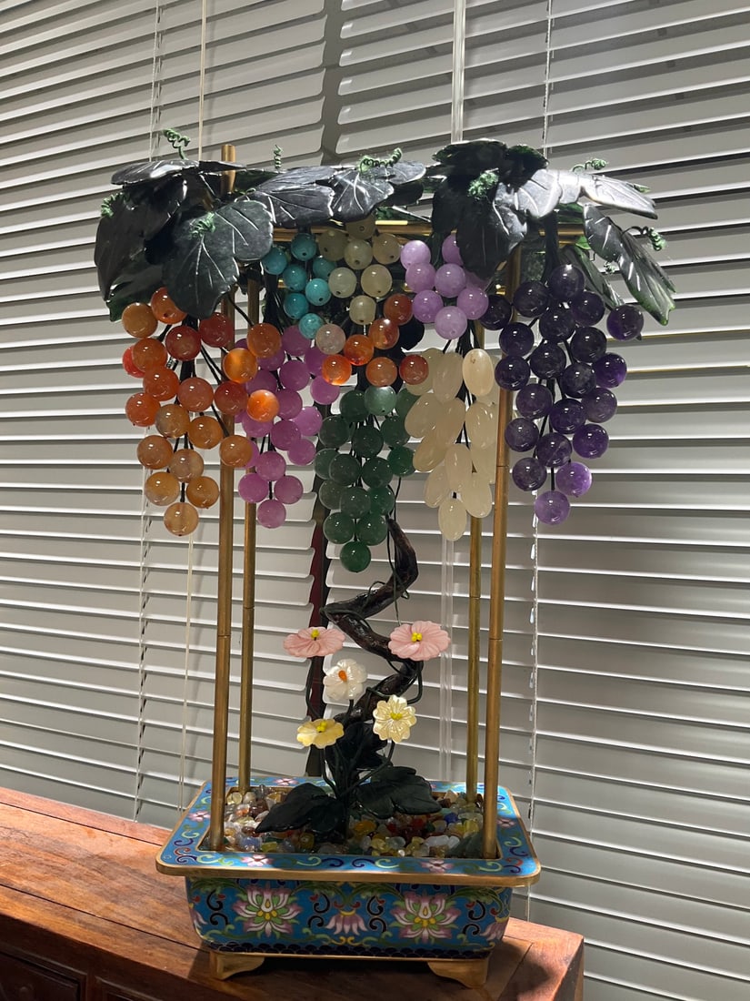 Qing Dynasty agate and jade bonsai (cloisonn ?? basin): The cloisonn pot is a multi treasure grape bonsai, 35cm high and 17cm wide. Various gemstones and jade stones are carved into bead grapes, with a cloisonn ?? enamel base, symbolizing abundant fruits. 
