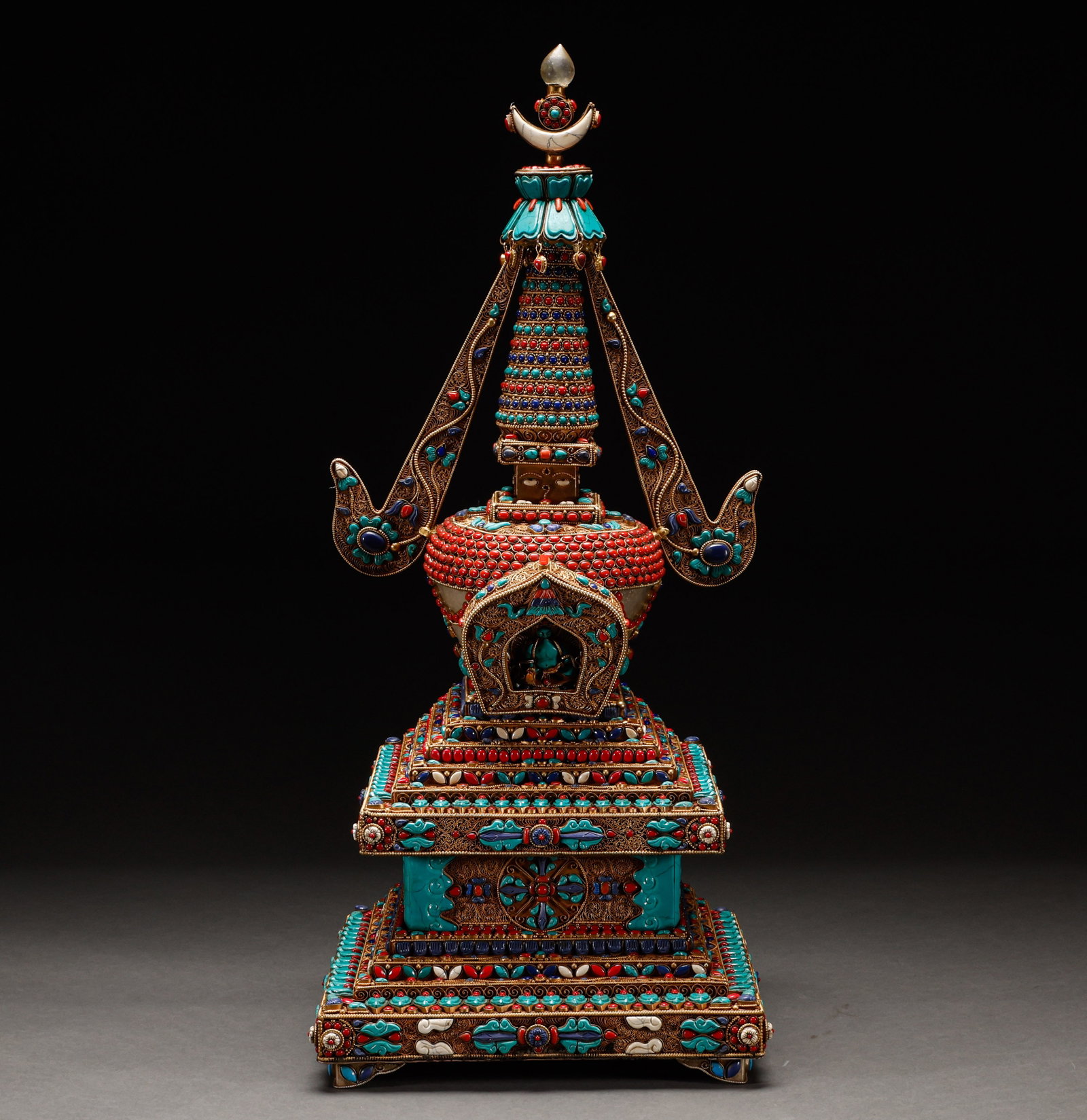 Qing Dynasty Copper Gilded Pagoda with Hundred Treasures Embedded: Qing-Dynasty Gilt-Bronze Buddhist Pagoda Inlaid with Assorted Treasures. Of superb material and workmanship alike, the piece stands 64 cm tall, is 28 cm wide, and weighs 8,525 g. With a composed expre