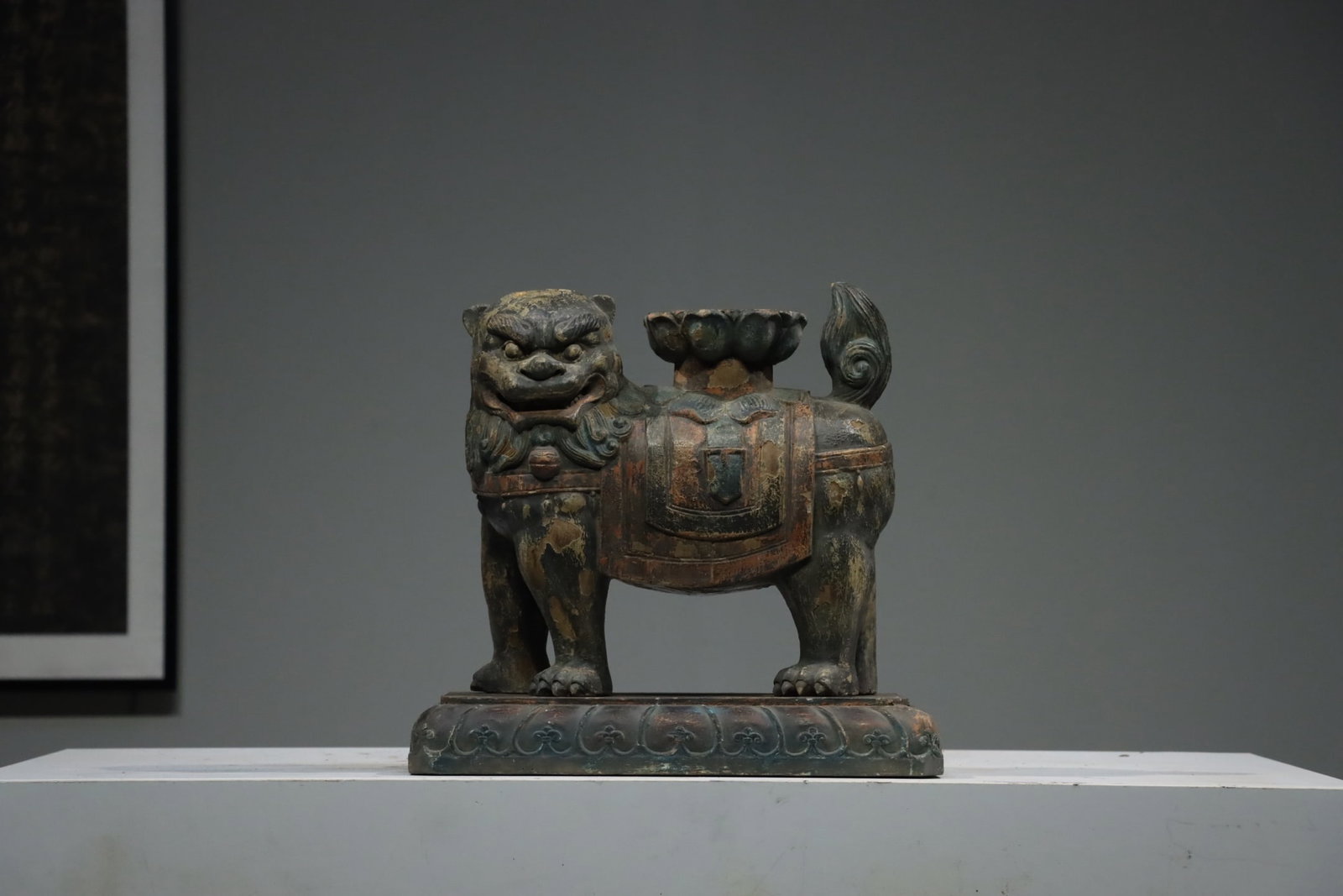 Qing Dynasty wooden lion ornaments: Qing-Dynasty Wooden Carving of a Lion. Splendid and dignified, bearing an air of grandeur, the piece stands 47 cm tall, and is 27 cm wide. The bronze is of pure quality with a settled patina, finely c