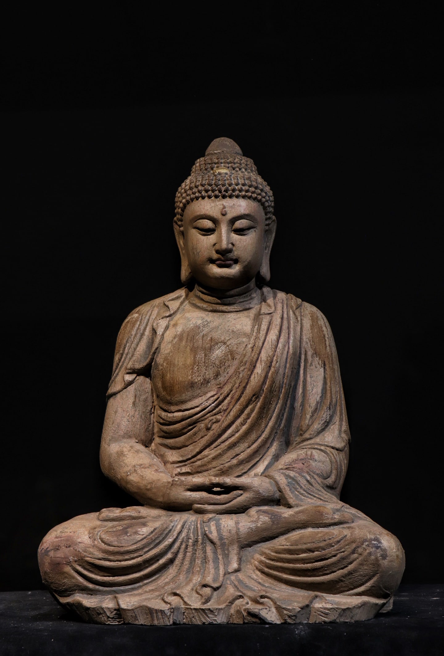 Wooden Carving of Shakyamuni Buddha Sitting in the Qing Dynasty: Qing-Dynasty Wooden Seated Shakyamuni Buddha. Of superb material and workmanship alike, the piece stands 54 cm tall, and is 39 cm wide. With a composed expression and a majestic bearing, it carries th