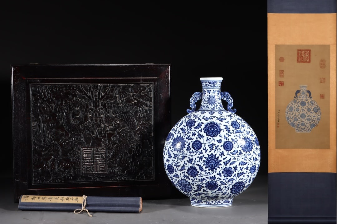 Qing Dynasty Blue and White Lotus Pattern Double Eared Flat Pot: Qing-Dynasty Blue-and-White Double-Handled Flat Vase with Interlocking Lotus Scroll. Meticulously worked with singular artistry, the piece stands 44 cm tall, and is 31 cm wide. The form is full, the g