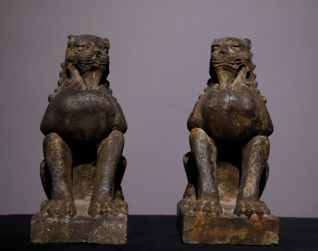 A pair of Qing Dynasty bluestone lions: Qing-Dynasty Bluestone Lion, a Pair. Steeped in antique charm, its patina warm and mellow, the piece stands 26 cm tall, and is 16 cm wide. Precious in material and naturally veined, carved to suit the