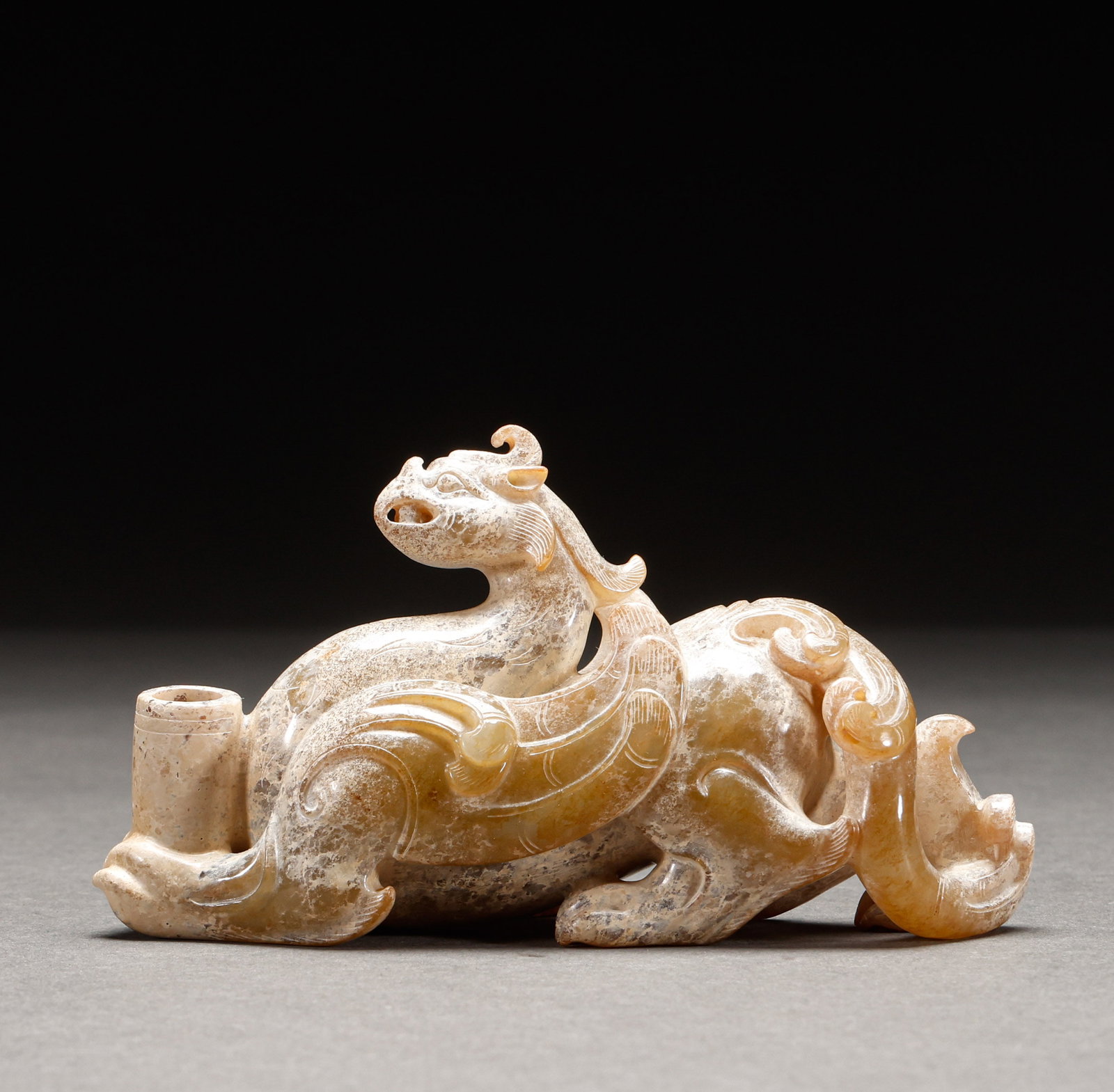 Hotan Yurui Beast before the Ming Dynasty: Pre-Ming Hetian Jade Auspicious Beast. Perfectly formed and full of distinctive charm, the piece stands 6.5 cm tall, is 11.5 cm wide, and weighs 233 g. Fine-grained and thickly patinated, complete in 
