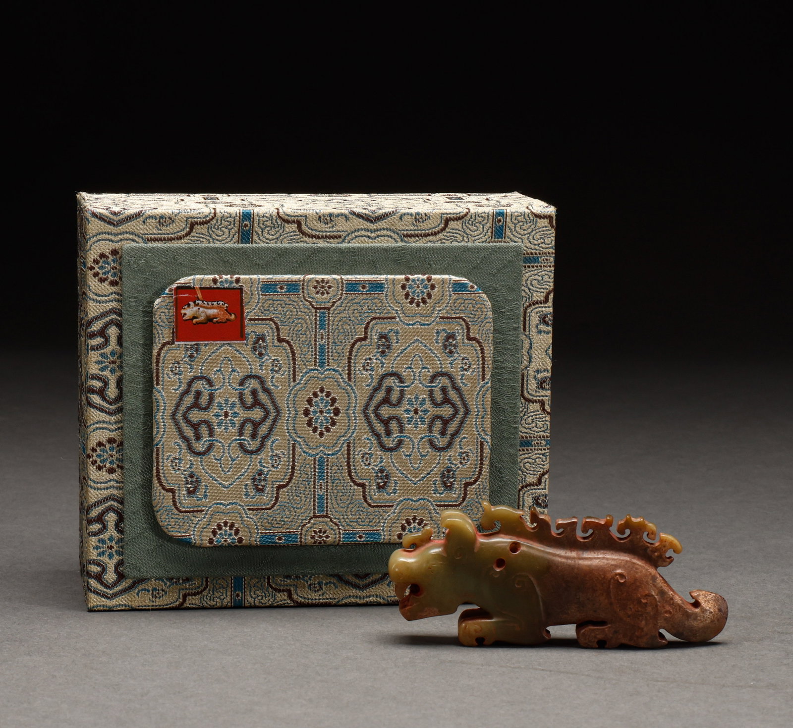 He Tian Yu Beast before the Ming Dynasty: Pre-Ming Hetian Jade Beast. Crafted with the consummate skill of a golden age, the piece stands 4 cm tall, is 10 cm wide, and weighs 92 g. The jade is warm and translucent with naturally mellow markin