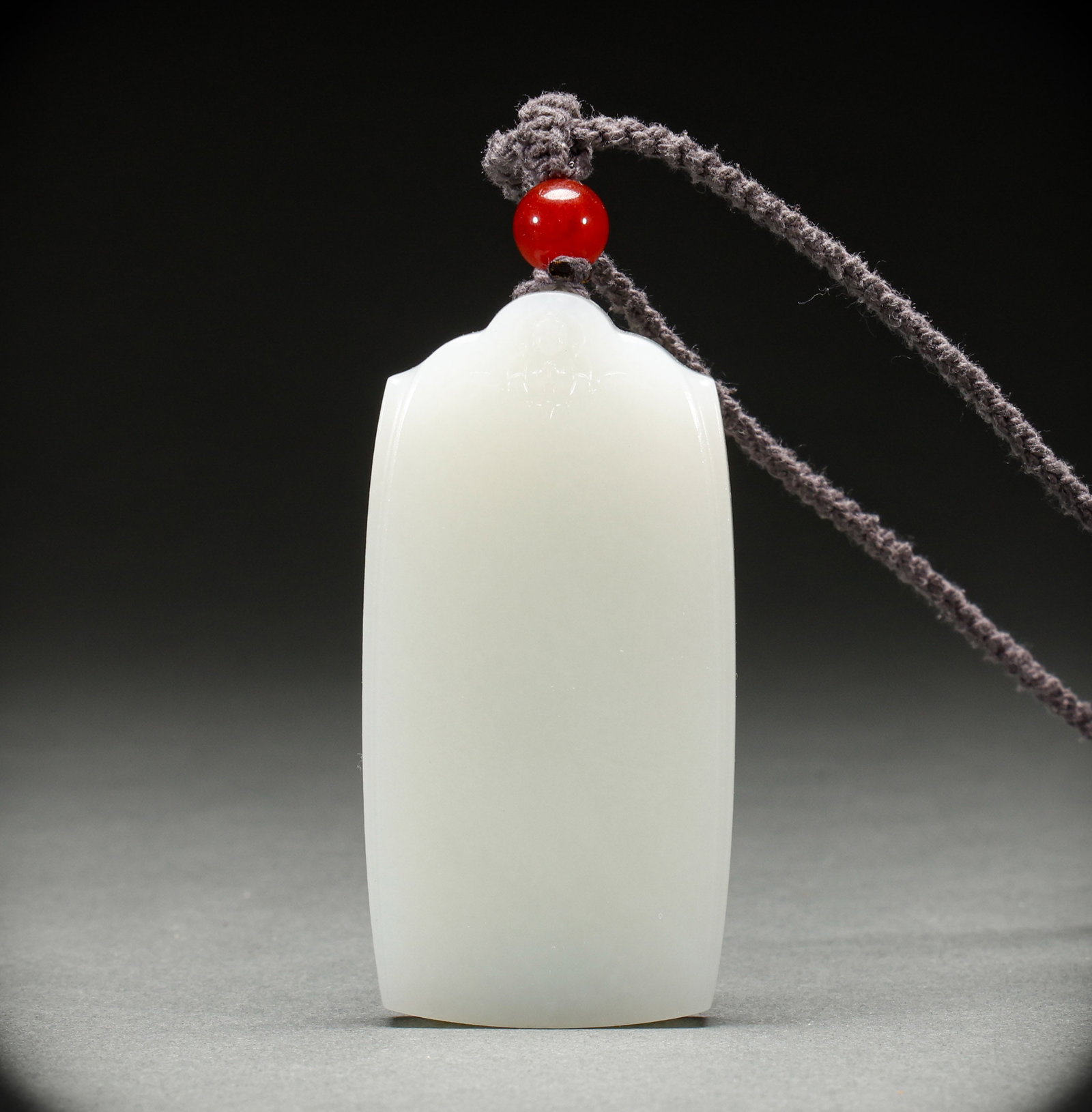 Hotan Jade Peace Token in Qing Dynasty: Qing-Dynasty Hetian Jade Peace Tablet. Well-proportioned in form and flowing in line, the piece stands 7.2 cm tall, is 4 cm wide, and weighs 84 g. The tone is rich and the lapidary work superb, the mo