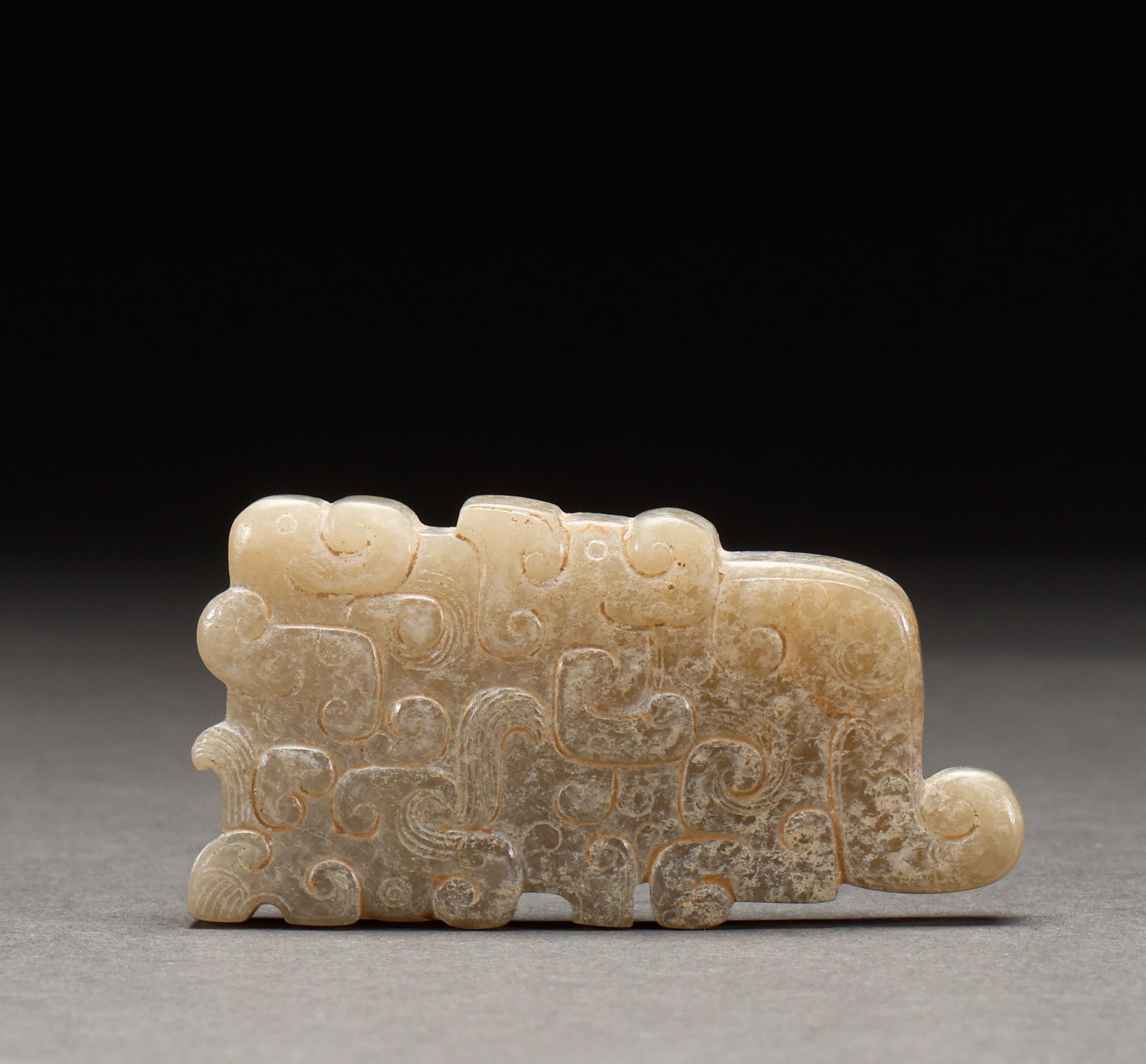 Hotan Jade accessories before the Ming Dynasty: Pre-Ming Hetian Jade Ornament. Steeped in antique charm, its patina warm and mellow, the piece stands 3.5 cm tall, is 7 cm wide, and weighs 56 g. The tone is rich and the lapidary work superb, the mot
