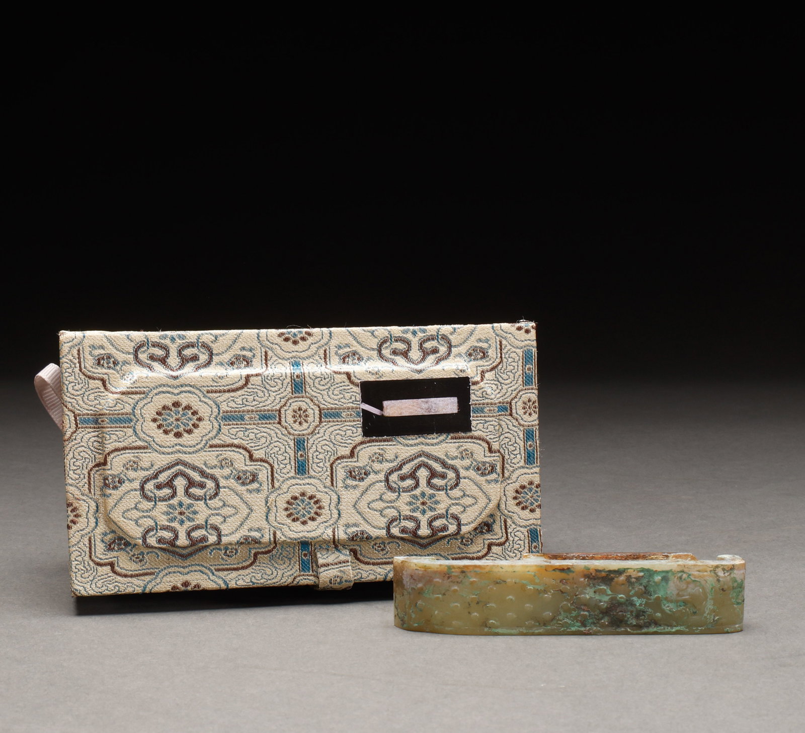 Hetian Jade Sword Ornament before the Ming Dynasty: Pre-Ming Hetian Jade Sword Fitting. Imposing in presence and radiant with vitality, the piece measures 10 cm in length, is 2 cm wide, and weighs 60 g. The jade is warm and translucent with naturally m